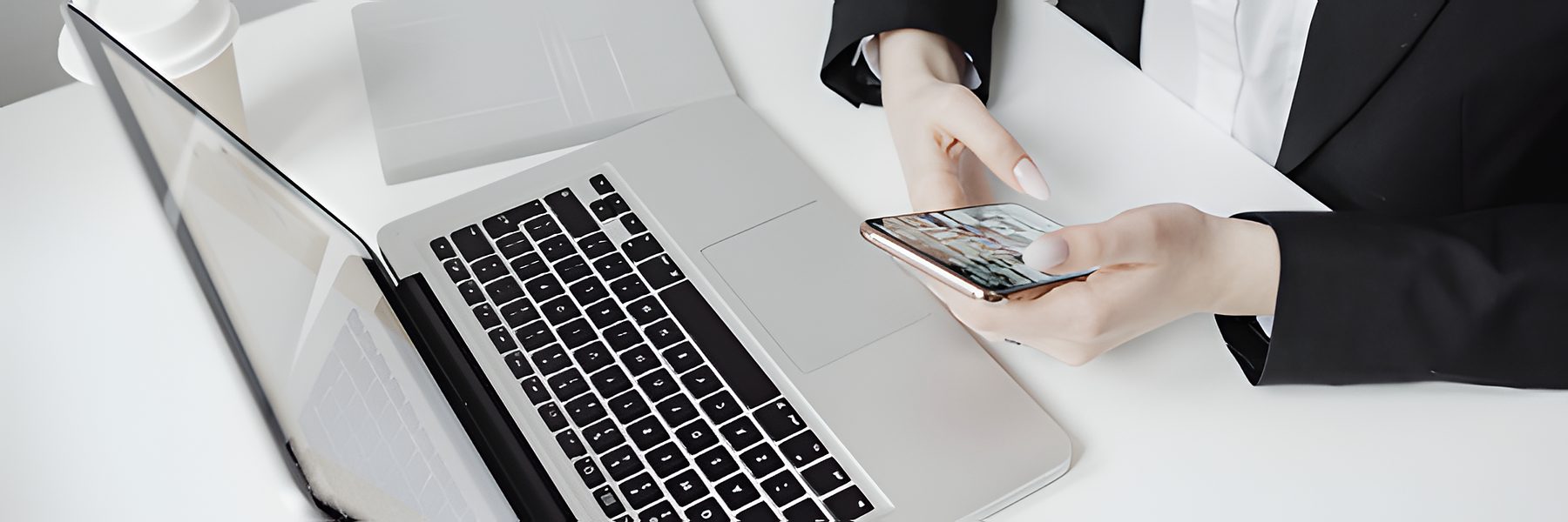 Marketer reviewing Canvas UGC creator videos on a phone beside a laptop