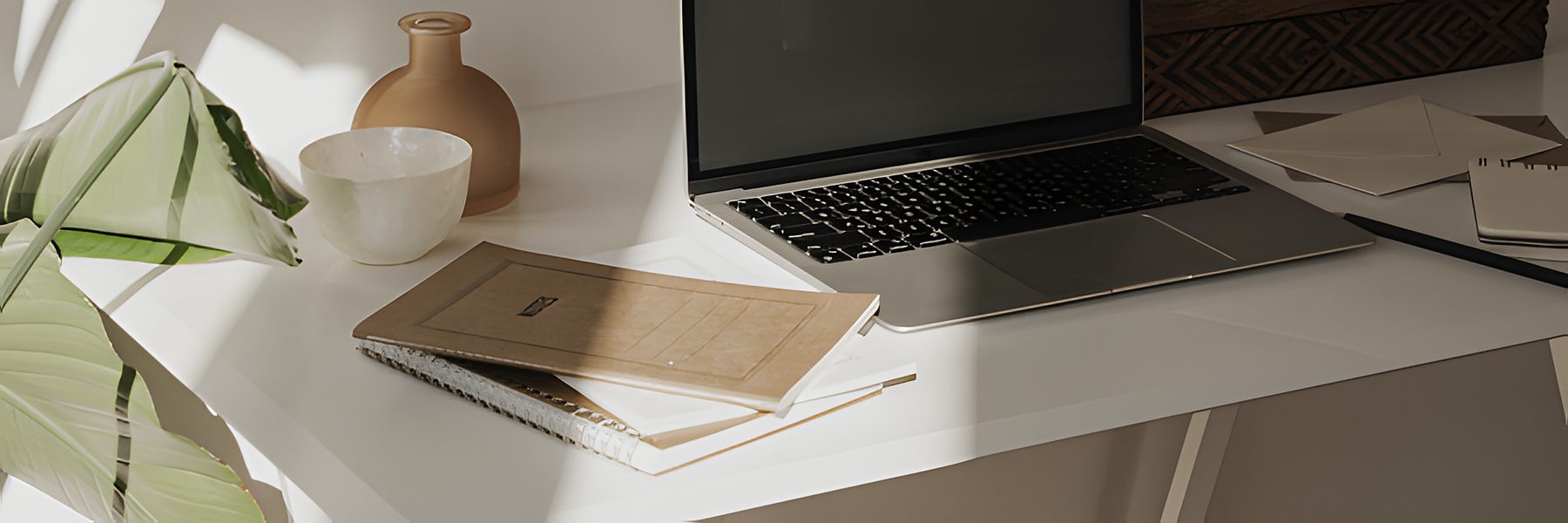 Desk with a laptop and notebooks
